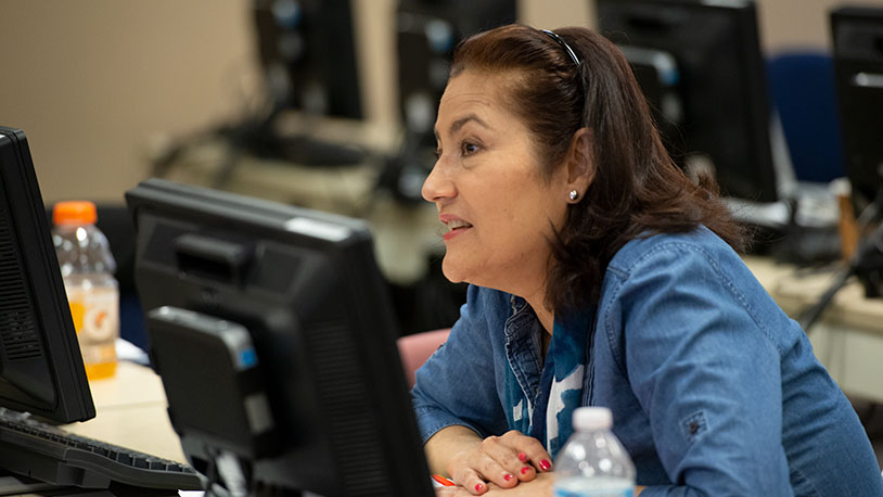 A female Hispanic adult MCC student in a classroom