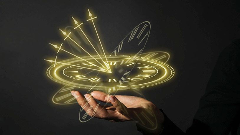 A human hand holding a clock