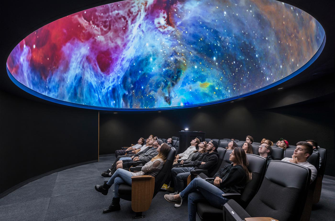 students look up to view a show in the MCC planetarium