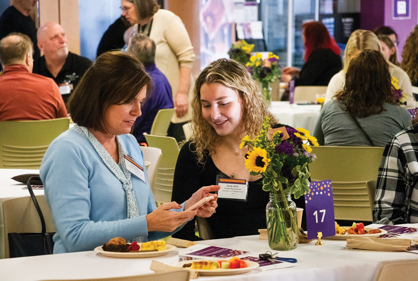 a student sits with a scholarship donor at the annual donor breakfast