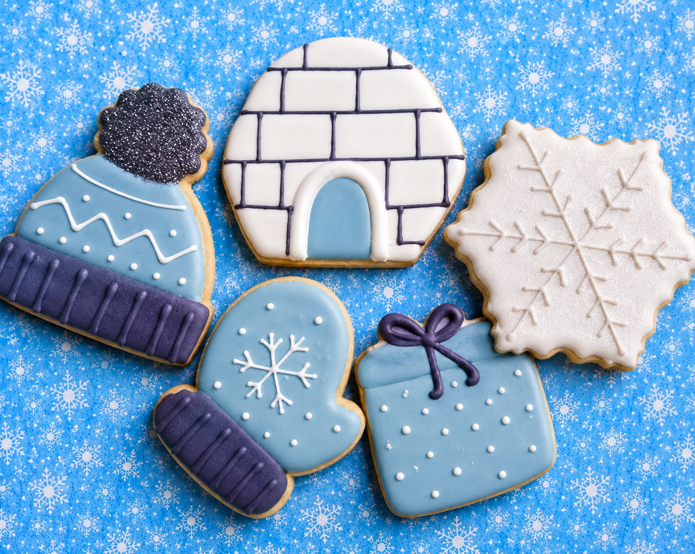 a variety of frosted cookies in winter shapes