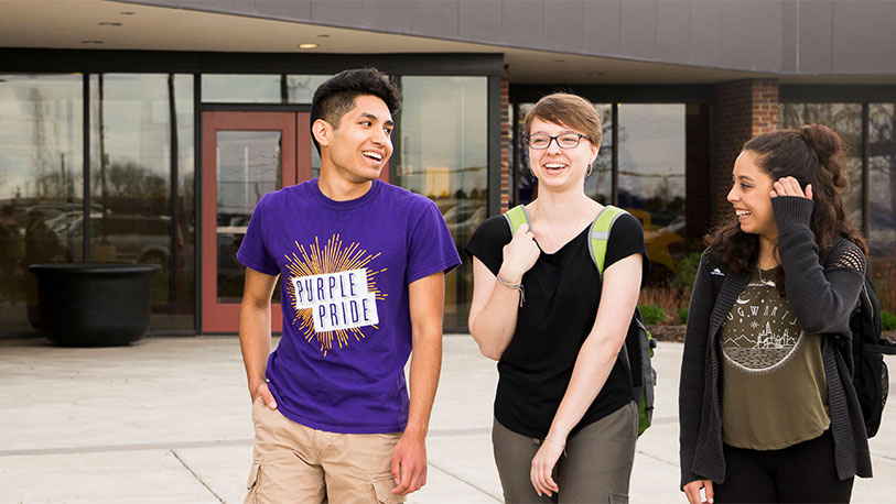 Three smiling MCC students in front of MCC