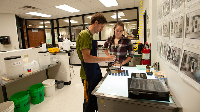 instructor assisting student with digital camera