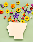a representation of a human head with flowers coming out of the top of it
