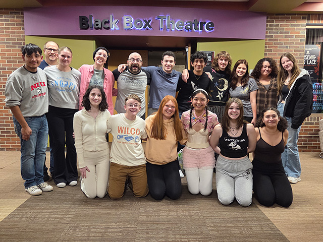 The cast and crew of I'm No Shakespeare stands in front the theatre in two rows