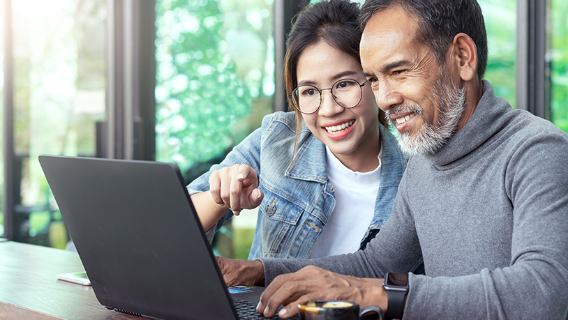 Spanish man with daughter at computer