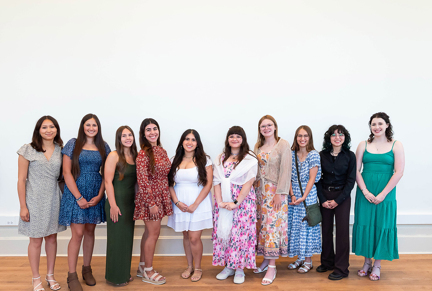 ten e2e recipients stand in front of a white wall