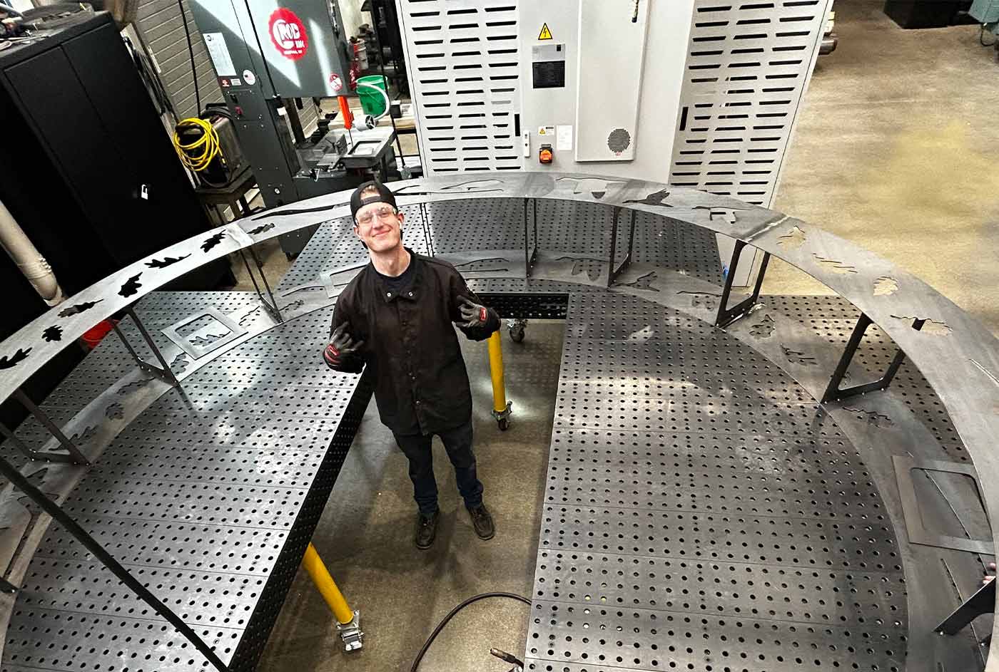 a welding student stands in the center of moon gate