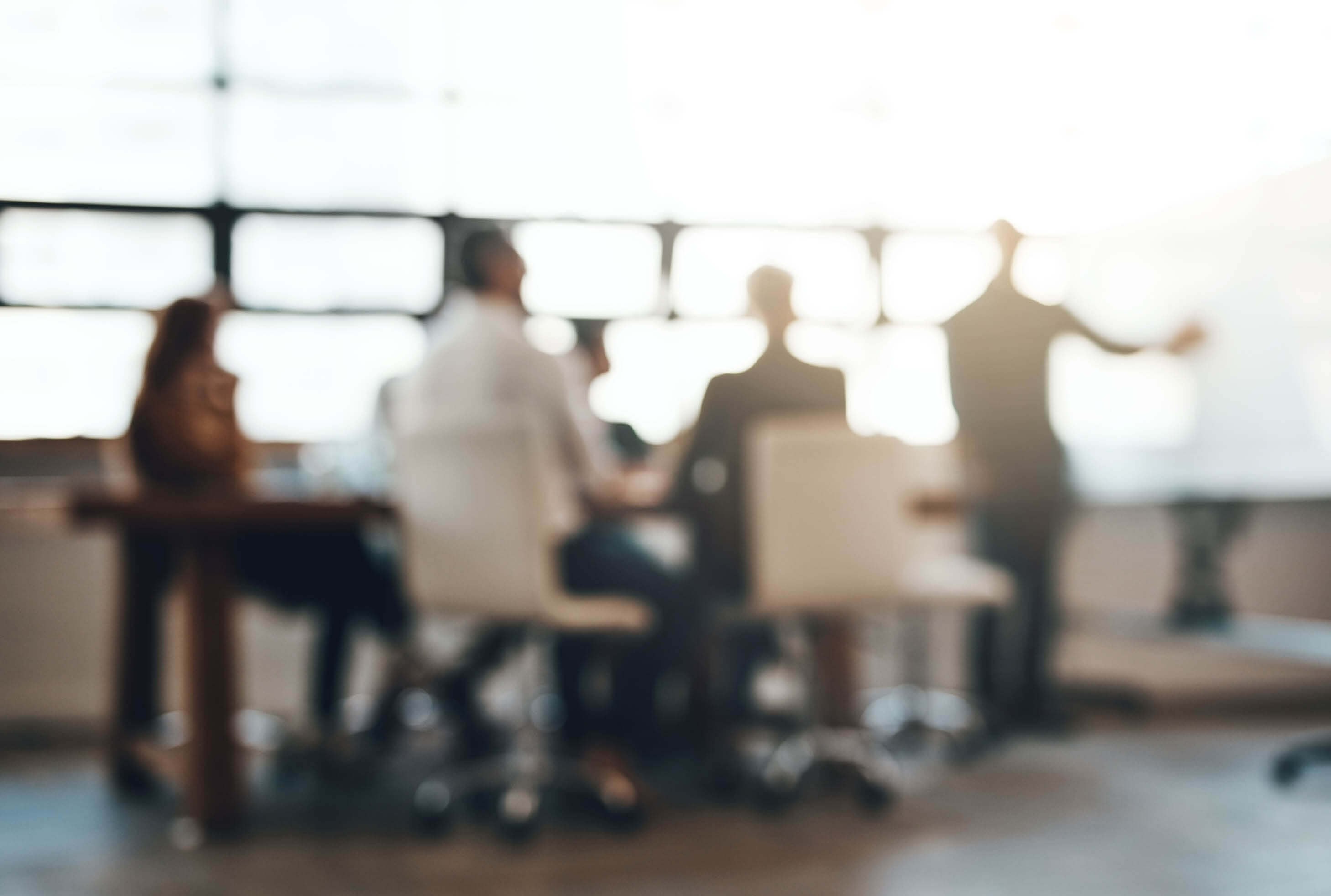 people gathered around table in conference room