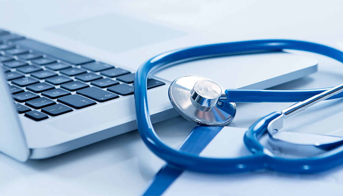 stethoscope laying on computer keyboard