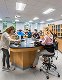 students looking through microscopes in science lab