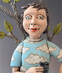 A clay figure of a woman holding a coffee cup