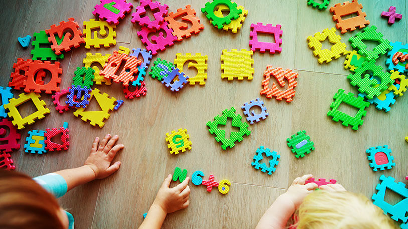 young kids learning with colorful tile block