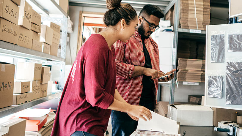 Supply chain manager going over logisitics with employee