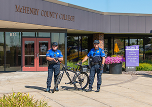 Two MCC Police Department Bicycle Patrol Officers standing beside bikes