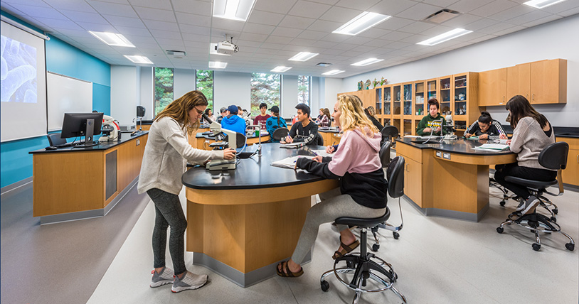 students looking through microscopes in science lab